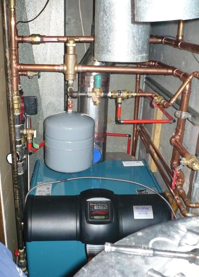 Precision boiler installation in a tight mechanical room showing expert craftsmanship